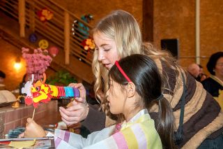 Rusty Rae/News-Register##Olivia Cho helps Anika Laido create a traditional Lunar New
Year dragon during the McMinnville celebration Saturday.
More than 700 people attended the first Lunar New Year
celebration here in more than a century.