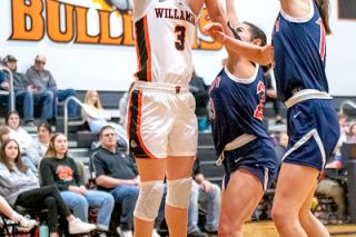 Rusty Rae/News-Register##Willamina’s Brianna Buswell shoots over two Kennedy defenders. Buswell finished with 11 points.