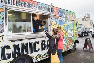 Rusty Rae / News-Register##
A Franz grilled cheese truck worker hands out grilled cheese bites to
McMinnville residents Friday in celebration of the start of YCAP s
annual fundraiser, The Melt Down. Sixty-two restaurants are
participating this year.