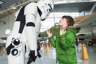 Marcus Larson/News-Register##

David Mohney, an information systems specialist at the Oregon Department of Fish and Wildlife who moonlights as an Imperial stormtrooper, talks with a very excited Jory Greene, 9. Mohney was among the  Star Wars  cosplayers from the Cloud City Garrison in Portland who came to the Evergreen Aviation & Space Museum for Reaching for the Stars, an annual day of activities and learning opportunities for people with developmental and physical disabilities.