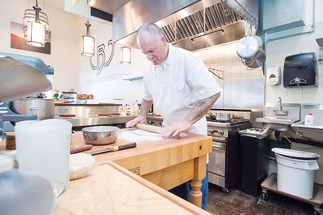 Marcus Larson/News-Register##Danny Wilser said he loves working in his new bakery’s kitchen, which glistens with stainless steel. The open space also makes it easy for him to chat with customers while he’s working.