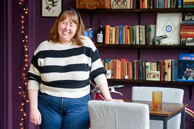 Rusty Rae/News-Register
##
Amy Griffith Strandberg, tasting room manager, recalls how much fun she had decorating the La Biblioteca space. Wanting it to look like an eccentric professor s office, she collected books and other artifacts to make customers feel comfortable.