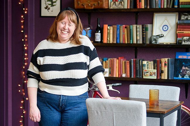 Rusty Rae/News-Register
##
Amy Griffith Strandberg, tasting room manager, recalls how much fun she had decorating the La Biblioteca space. Wanting it to look like an eccentric professor s office, she collected books and other artifacts to make customers feel comfortable.