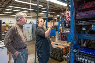 Rachel Thompson/News-Register##With the newsroom along with other News-Register departments now located at the Oregon Lithoprint Inc. facility, press manager Joe Cornelison, right, shows managing editor Kirby Neumann-Rea around the web press system.