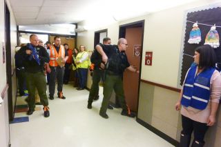 Starla Pointer / News-Register##
Watched by school observers, Yamhill County Sheriff s deputies look for people hiding during a drill at Wascher School. Educators practice so they ll be ready to protect students in any circumstance.