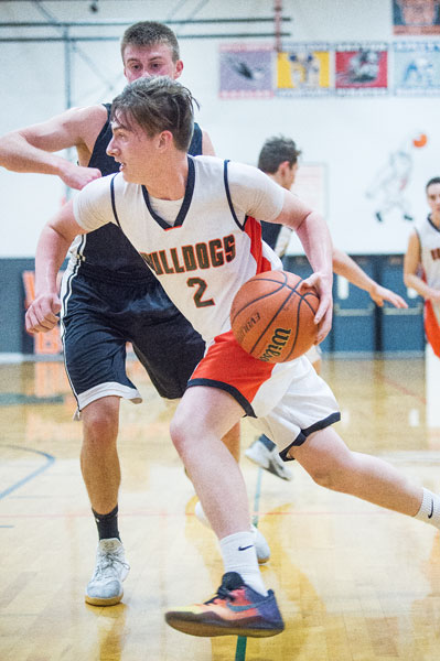 Marcus Larson/News-Register
Willamina s Nick Colton drives to the basket as he looks for an open man to pass to.