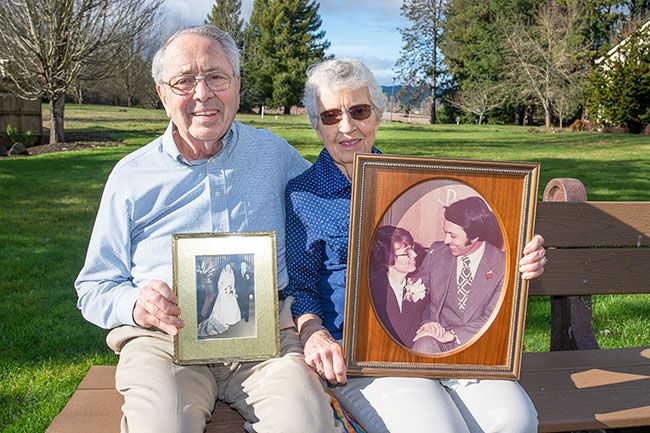 Marcus Larson/News-Register##Bernie and Roz Turner show photos from their wedding in 1952 and their 25th anniversary in 1977. In January, they celebrated 69 years of marriage and telling each other  I love you  many times a day.