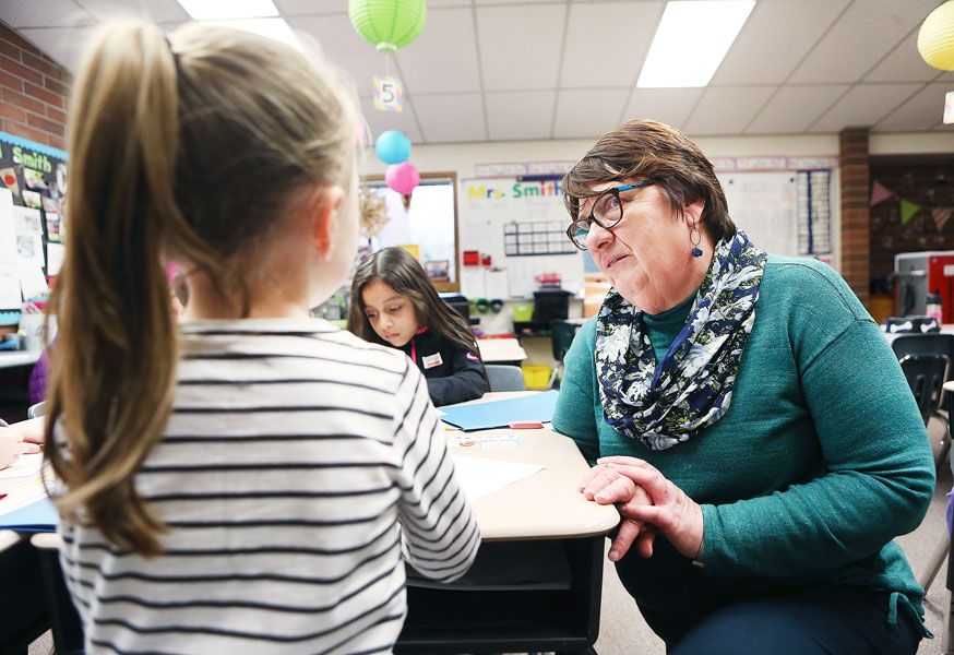 Rockne Roll/News-Register##
Retired teacher Pam Tate, right, talks with a student during the Wascher writing festival.