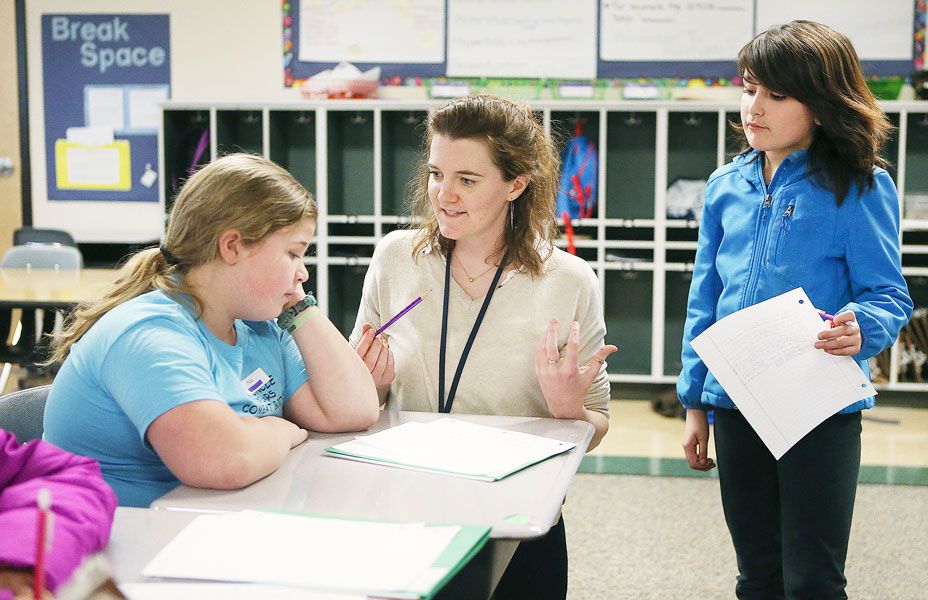 Rockne Roll/News-Register##
From left, fifth-grader Ayla Sullens works with teacher Zealand Reynolds as Breonna Sallee looks on during the Wednesday, Feb. 1, session of the writing festival.