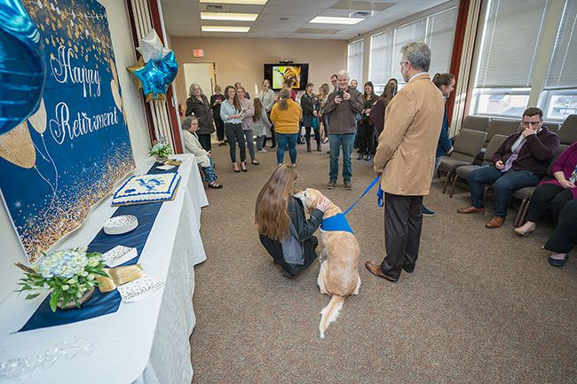 Rachel Thompson##Kwynn Johnson kneels for a nuzzle from Marybeth as her father, County Commissioner Kit Johnson, snaps a photo. Holding Marybeth’s leash is District Attorney Brad Berry
