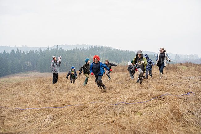 Rachel Thompson/News-Register
##
Pretending to be predators chasing prey, Outdoor Education Adventures students run across a meadow at Miller Woods during a non-school day camp Feb. 3. Theresa Crain, who leads the program with Neyssa Hays, is on the left.