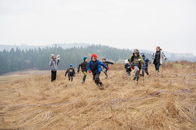 Rachel Thompson/News-Register
##
Pretending to be predators chasing prey, Outdoor Education Adventures students run across a meadow at Miller Woods during a non-school day camp Feb. 3. Theresa Crain, who leads the program with Neyssa Hays, is on the left.