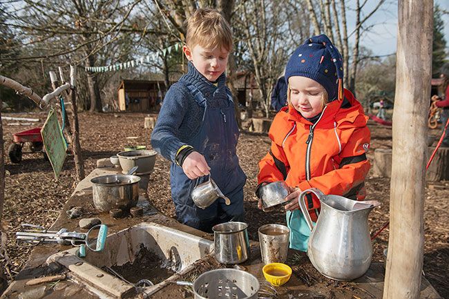 Rusty Rae/News-Register
##
Lev Martin and Theo Darm cook up some specialities in the mud kitchen at the Maple Grove preschool. Children’s play helps shape the lessons at the outdoor school.