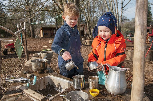 Rusty Rae/News-Register
##
Lev Martin and Theo Darm cook up some specialities in the mud kitchen at the Maple Grove preschool. Children’s play helps shape the lessons at the outdoor school.