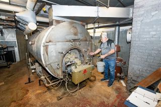 Rusty Rae/News-Register##Custodian Jeff Buczynski  tends to the Amity Middle School boiler, which came off a ship, and is more than 75 years old. Plans for the building are yet to be determined, but no bond money would be used on the aging middle school property.