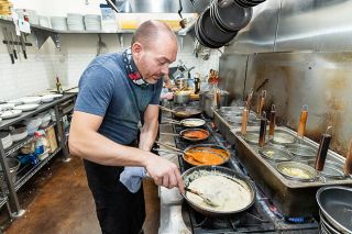 Marcus Larson/News-Register##The focus is on food and family for Dario Pisoni, owner and chef of Rosmarina Osteria Italiana, shown creating dishes in the kitchen of his Newberg restaurant.