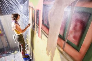 Rusty Rae/News-Register##Painter Ashley Hope works on panels for the Rose Marie Caughran mural, which will hang on a building at Third and Cowls streets