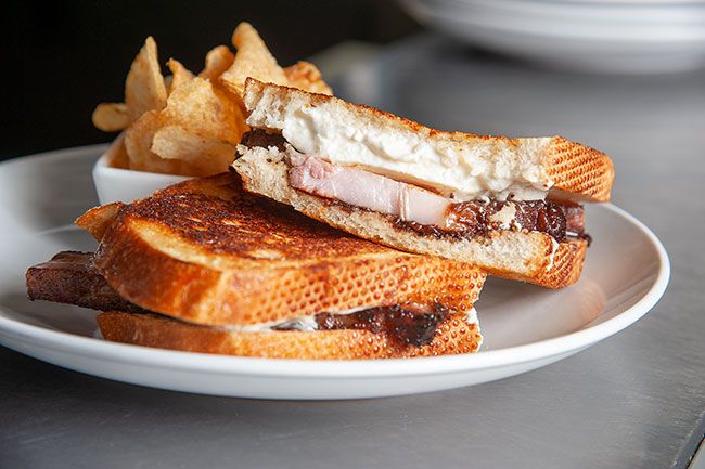 Rusty Rae/News-Register##Horse radish chef Mayy Zangara serves up the PB&JK, which stands for pork belly, burrata cheese, fig jam and  we re not kidding. 