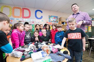 Marcus Larson/News-Register##
Rob Whitaker and his second grade class show off the numerous pairs of socks they collected in the last week.