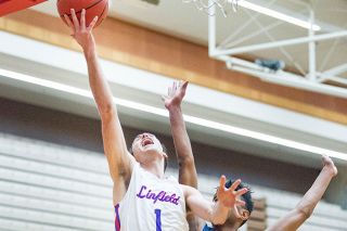 Marcus Larson/News-Register##
Linfield guard Tanner Autencio flies toward the hoop for two points during Tuesday’s 91-84 Wildcat win over George Fox. Autencio paced Linfield with 21 points, including 16 in the second half. Marcus Larson/News-Register##
Linfield guard Tanner Autencio flies toward the hoop for two points during Tuesday’s 91-84 Wildcat win over George Fox. Autencio paced Linfield with 21 points, including 16 in the second half.