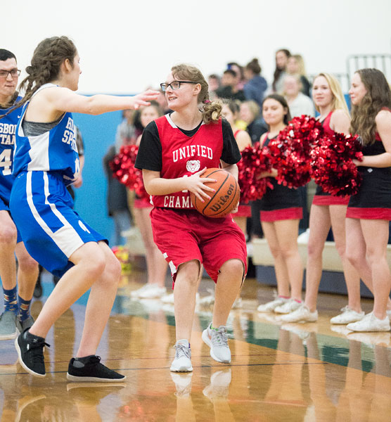 Marcus Larson/News-Register##
Tori Tipler scans the court for an open teammate while her fans and cheerleaders support her in the background.