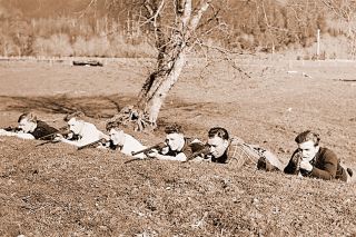 Image: Oregon Historical Society##
A line of Tillamook Guerilla Rifle Club members practice taking up a battle position behind a berm in March 1942, in this photo by an Oregon Journal photographer.