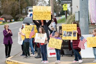 Rusty Rae/News-Register##Yamhill County Commissioner Mary Starrett looks on as parents and students protest mask mandates Wednesday in Yamhill. The Yamhill Carlton School District says it will make masks optional when the state gives it a choice on March 31.