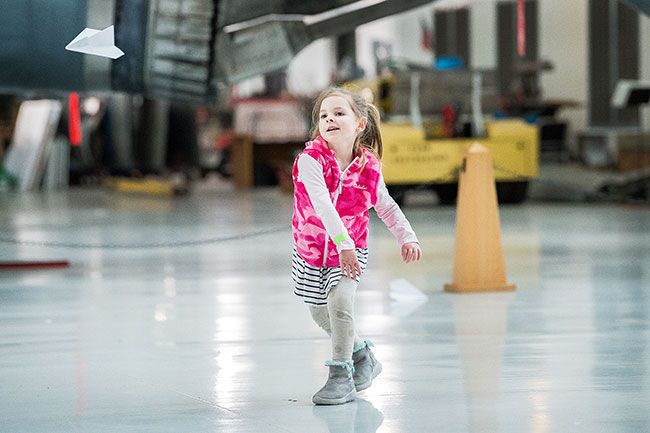 Marcus Larson/News-Register##
Five-year-old Piper Hunter throws her paper airplane as hard as she can while testing its flight characteristics.