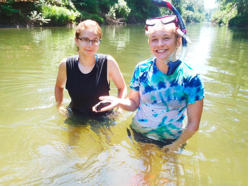Submitted photo ##
Linfield Students Bronwyn Boyd and Sarah Schmidt discover a piece of megafauna bone while scouting fossil locations on the South Yamhill.