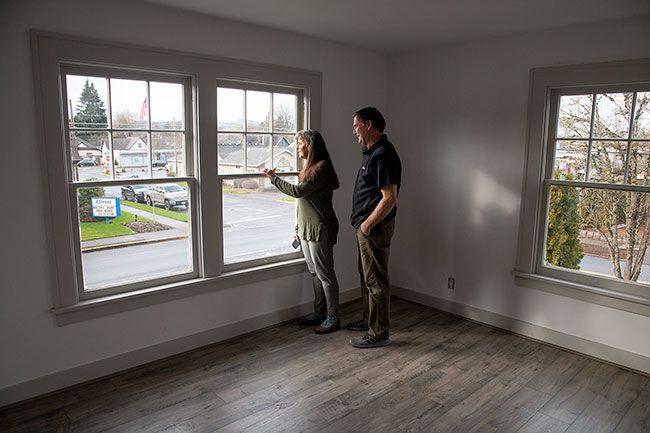 Rusty Rae/News-Register
##
Sally and Doug New check out the view from one of the renovated offices in their building at 734 N.E. Baker St. Doug inherited the building from his parents, Don and Leah New. His father used a garage in the back for his  man cave. 