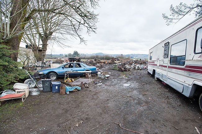 Marcus Larson/News-Register##
The men who were living in RVs have left the Hendricks Road property, but piles of debris, scrap metal and other items remains. Several motor homes were towed away Thursday afternoon.