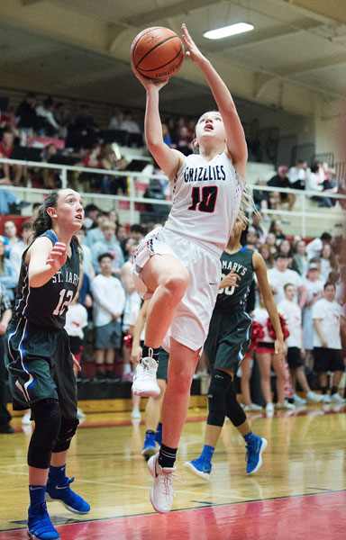 Marcus Larson/News-Register ##
Kayla Heuberger drives for an open lay-up against St. Mary s in the Grizzlies opening round of the state 6A girls  basketball tournament.