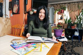 Rusty Rae/News-Register ## Elide Sanchez Rivera s mother encouraged her to read as a child by buying her books of her own. Now working for the statewide SMART program Sanchez Rivera still has kept much of her childhood library.