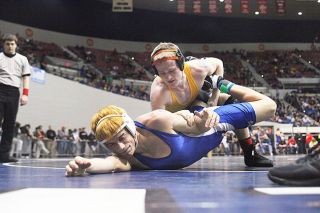Rockne Roll/News-Register ##
Sheridan senior Justin Acuff (in yellow and blue) pinned Hoyer Deleon of Nyssa in 2 minutes, 53 seconds in the 3A 138-pound quarterfinals Friday, Feb. 27 at Veterans Memorial Coliseum in Portland. Acuff pinned all of his opponents on his way to the Class 3A 138-pound state title, his third.