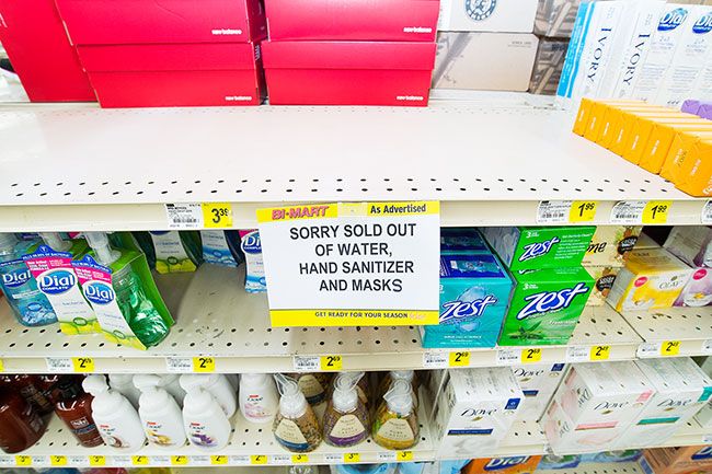 Marcus Larson/News-Register##
Bi-Mart posts signs noting that hand sanitizer, bottled water and face masks were mostly sold out by Monday morning.