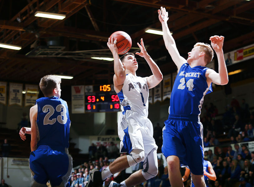Rockne Roll/News-Register##
Brandon Wilson of Amity (1) flies past two Cavaliers for a layup in the Warriors  OSAA Class 3A State Championship consolation game against Blanchet Catholic on Friday, March 3, at the Pirate Palace in Coos Bay.