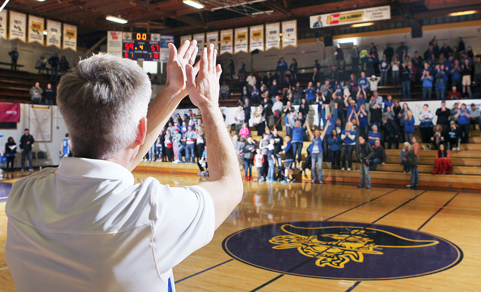 Rockne Roll/News-Register##
Amity head coach Scott Nelson, left, applauds Amity fans following the Warriors’ first OSAA Class 3A State Championship victory in eight tries. The Warriors downed Blanchet Catholic, 59-57, in a consolation game.