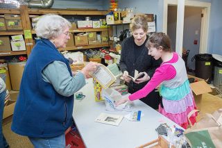 Marcus Larson/News-Register##Carol Hansen, Shawn McRae and daughter Savanah sort items for the Presbyterian Church’s annual rummage sale. Volunteers spend Mondays, all year, sorting and cleaning donations in preparation for the early March event.