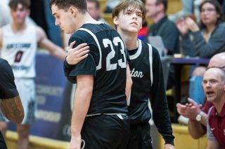 Marcus Larson/News-Register##
Dayton’s Tyler Spink is comforted by teammate Benji Hudson after Spink’s three-point attempt was blocked and he committed a traveling violation, effectively dashing the Pirates’ hopes for third place at the OSAA State Championships..