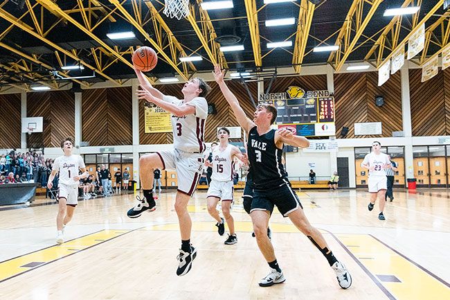 Marcus Larson/News-Register##
Dayton sophomore guard Boston Hodges elevates for a reverse lay-in during the Pirates  postseason contest against Vale.