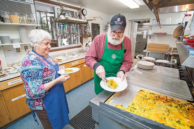 Marcus Larson/News-Register ## Vicky Bay and Darwin Scott plate up slices of quiche in the soup kitchen’s commercial-grade kitchen. When the nonprofit feeding ministry started, cooks used home appliances; community donations have helped install a better stove, dishwasher and freezer.
