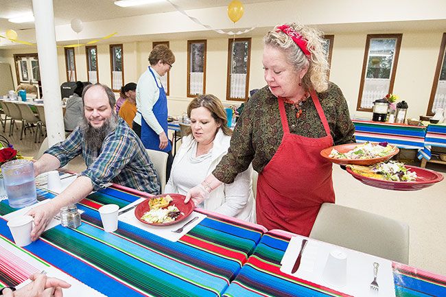 Marcus Larson/News-Register ## Soup kitchen chef and manager Robin Miguel serves guests. She said it’s important to bring food to them, rather than having them stand in line — just as the mission statement says, it’s about treating them as you would a visitor to your own home.