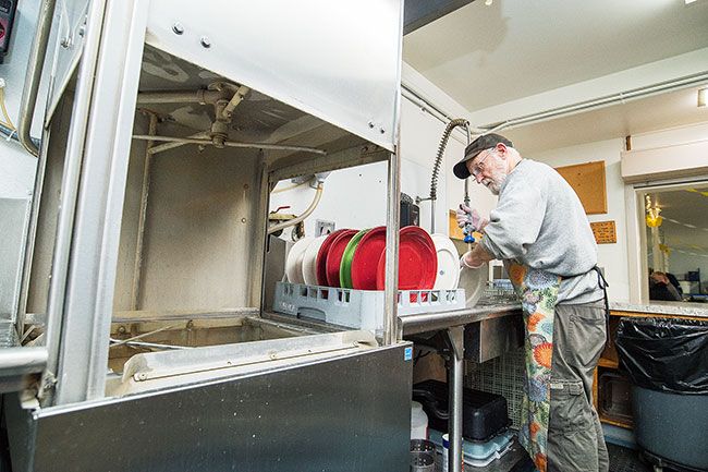 Marcus Larson/News-Register ##
Bill Murray washes dishes in the soup kitchen’s commercial washer, which was purchased through a fundraising effort by the Chamber Leadership group