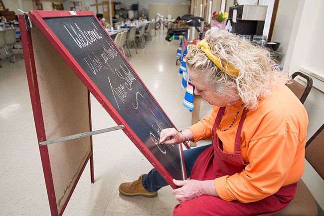 Marcus Larson/News-Register ##
Manager Robin Miguel notes the special of the day on a signboard. Guests like to know what will be served that night, she said.