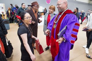 Marcus Larson/News-Register
##
Linfield President Miles K. Davis chats with student Alyssa Kuwamoto during the post-inauguration party. During his inauguration, he told students,  You re the reason I m here. 