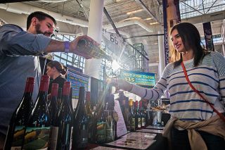 Marcus Larson/News-Register file photo##Pike Road Wines manager Dane Campbell pours a taste of Pinot gris for Emily Boone during the 2019 Wine & Food Classic. The event returns this year after a two-year break during the COVID-19 pandemic.
