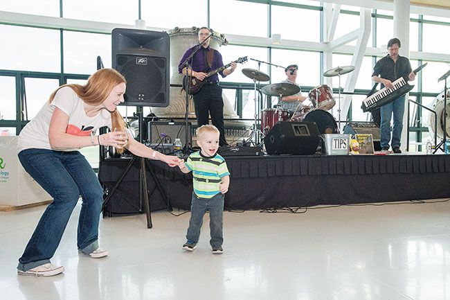 Marcus Larson/News-Register ##
Megan Sandmann dances with her son Michael to live music performed by The Jake Blair Band at last year’s  SIP! Wine and Food Classic. The blues band returns this weekend to the event to entertain the crowds.