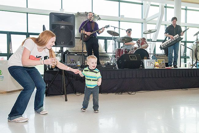 Marcus Larson/News-Register ##
Megan Sandmann dances with her son Michael to live music performed by The Jake Blair Band at last year’s  SIP! Wine and Food Classic. The blues band returns this weekend to the event to entertain the crowds.