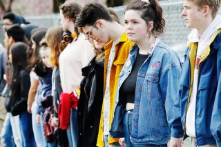 Rockne Roll/News-Register##
McMinnville High School student Brenna Spahn and other students old hands as a show of solidarity during a student walk-out Wednesday, March 14, as part of National School Walk-Out Day.