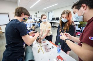 Rusty Rae/News-Register##Charles Weigant, Siri Nordstrom, Kylie Warner and teacher Jordan Slavish work on their rocketry team’s wiring and engine parts in their classroom at Yamhill Carlton High School. The team is preparing for a trip to a NASA competition in Alabama in late April.